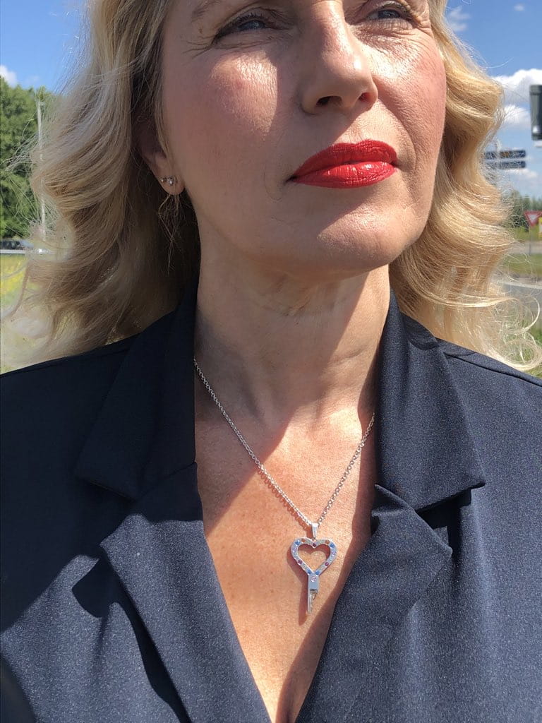 Elegant woman wearing the Colour your Life chastity key in Sterling silver